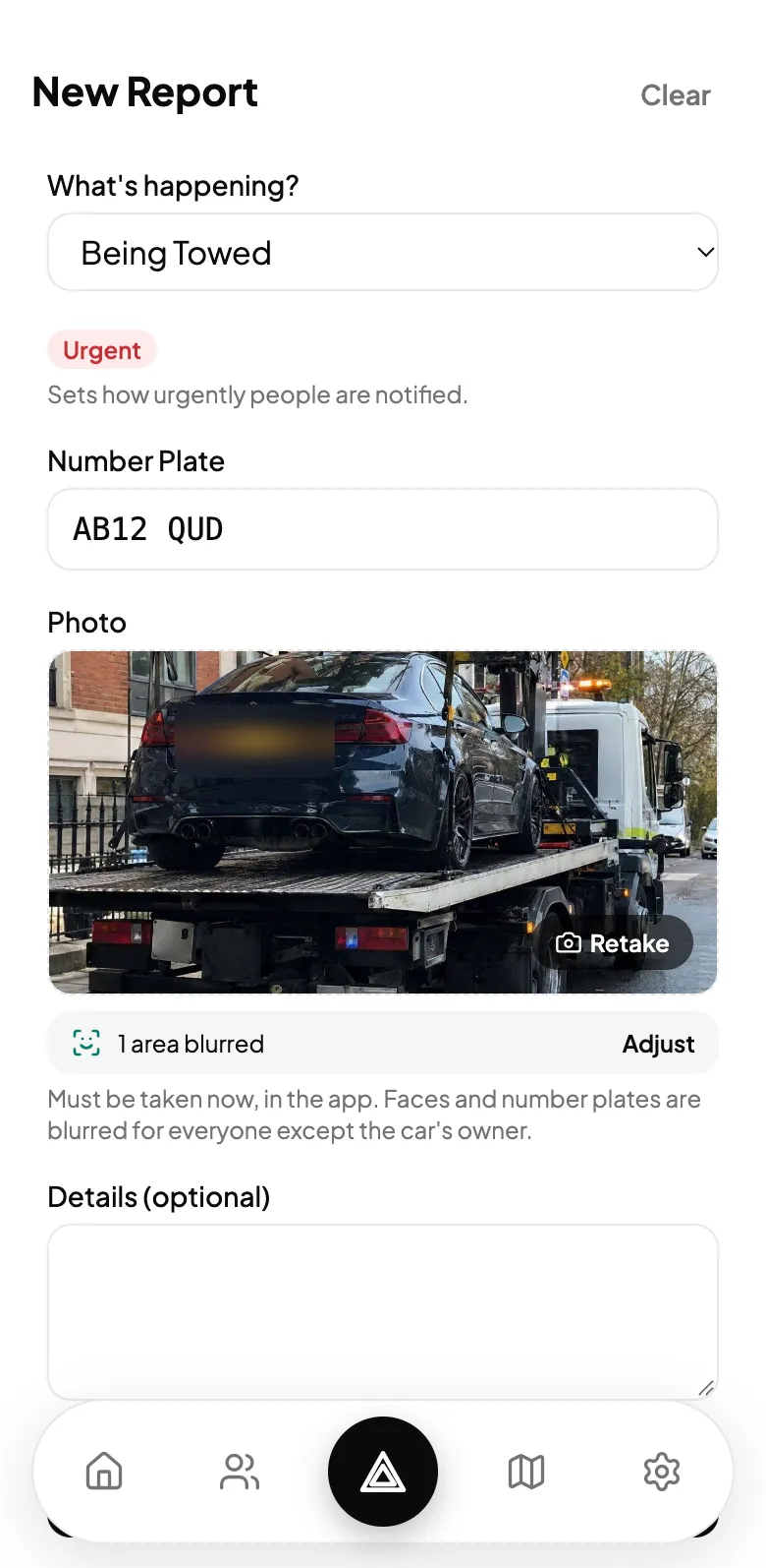 The report with the number plate typed in and a photo of the car on a tow truck, taken in the app, with the plate area blurred.